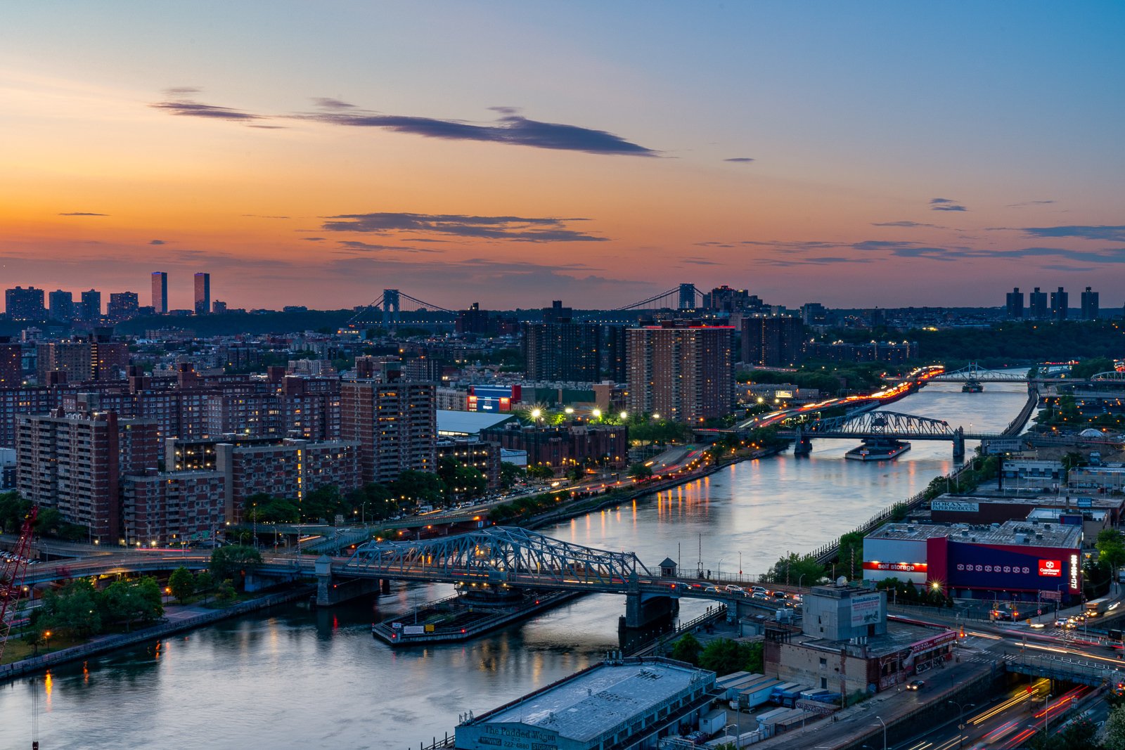 The Mott Haven streetscape at dusk, looking toward the Manhattan skyline