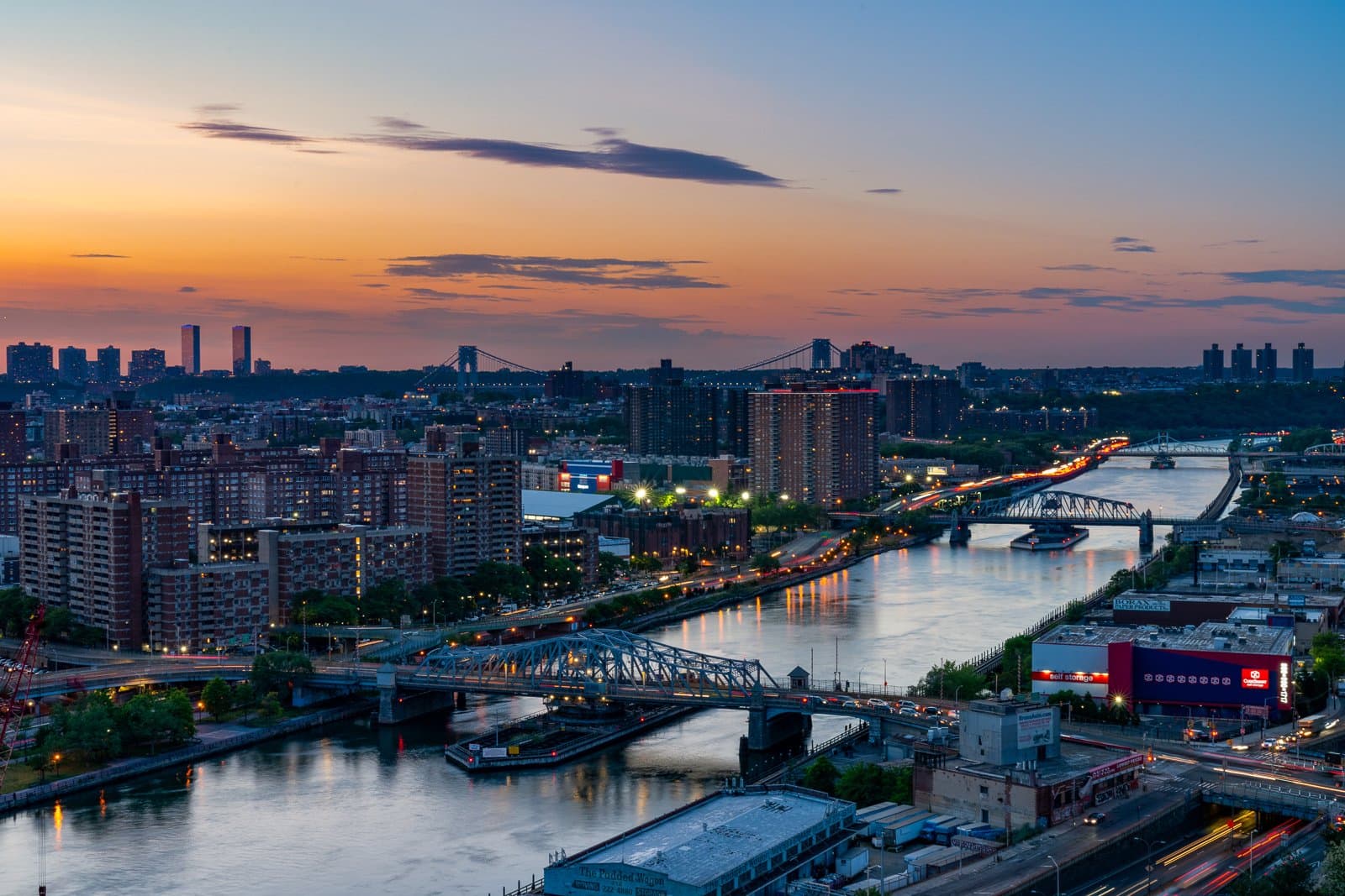 The Mott Haven streetscape at dusk, looking toward the Manhattan skyline
