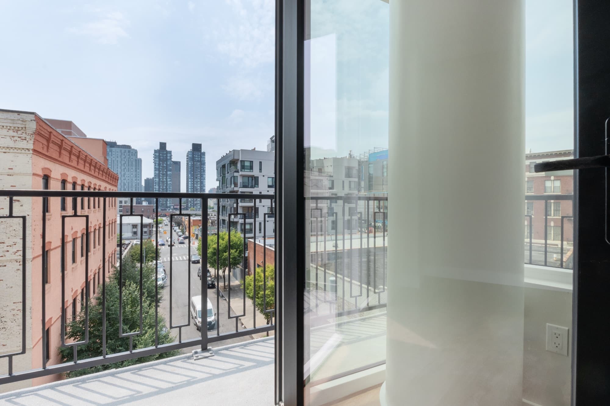 A residence interior at The Astelle in Mott Haven, with the South Bronx framed through the windows.